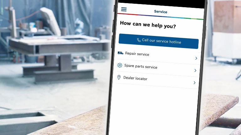A smartphone shows the Bosch Professional Service area in a workshop.