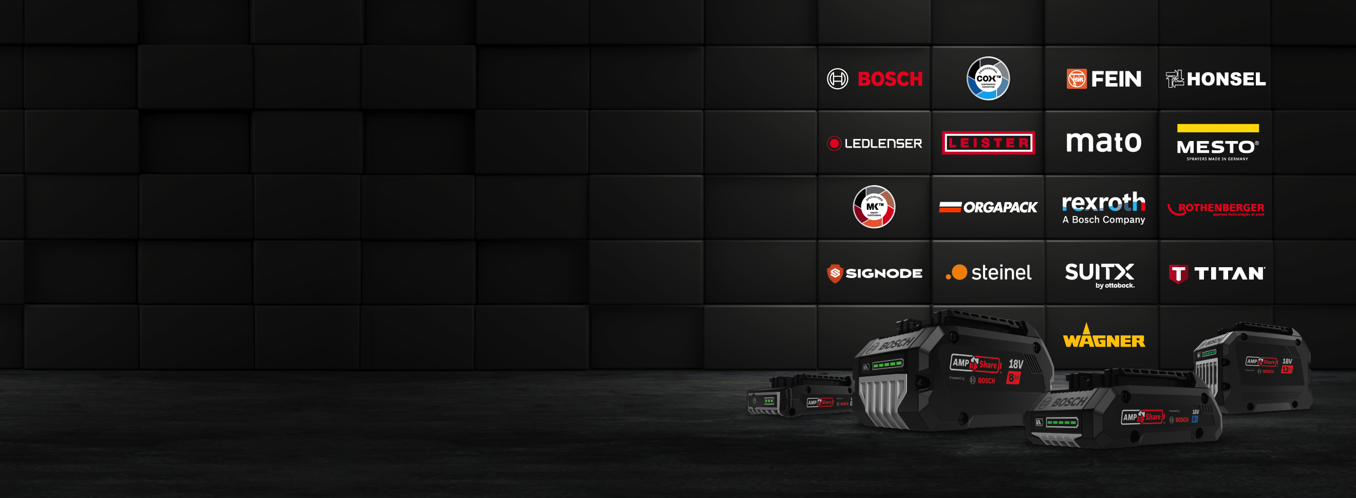 Three Bosch Professional batteries are on a dark surface.