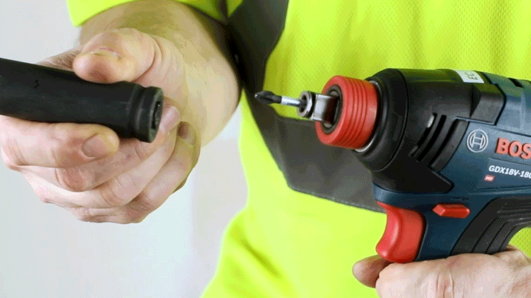 Bosch Professional cordless screwdriver in hand, tool attachment is being changed.