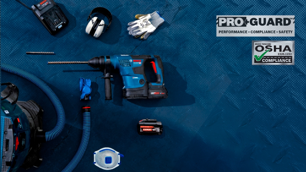 A blue Bosch Professional cordless hammer drill lies on a blue surface, surrounded by accessories and protective clothing.