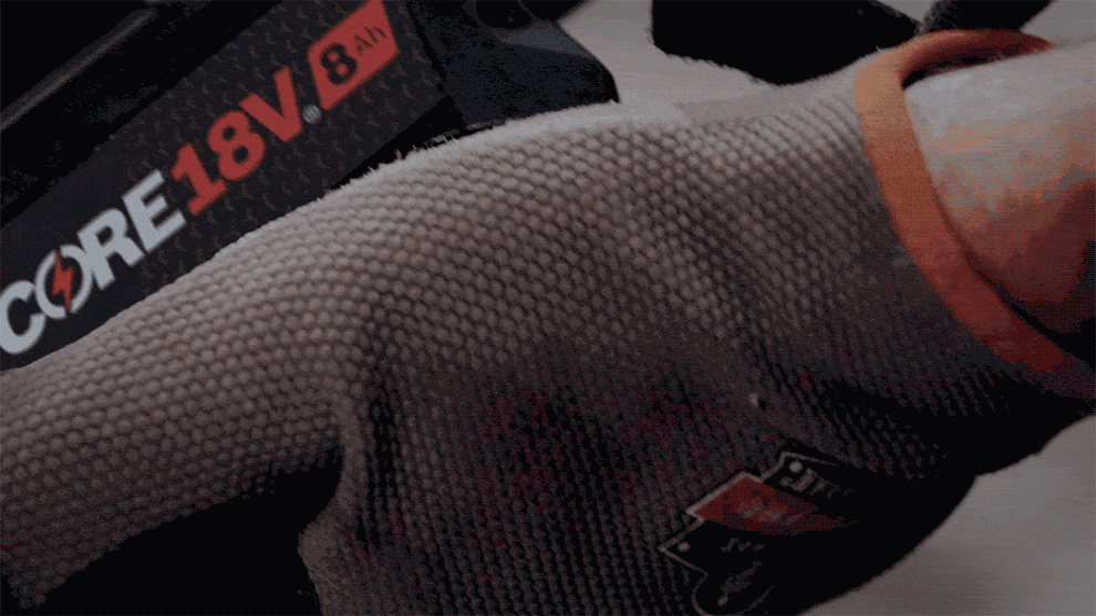 Close-up of a glove with Bosch CORE 18V battery label.