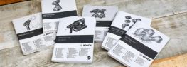 Seis manuales de instrucciones para herramientas Bosch Professional están sobre un fondo de madera clara.